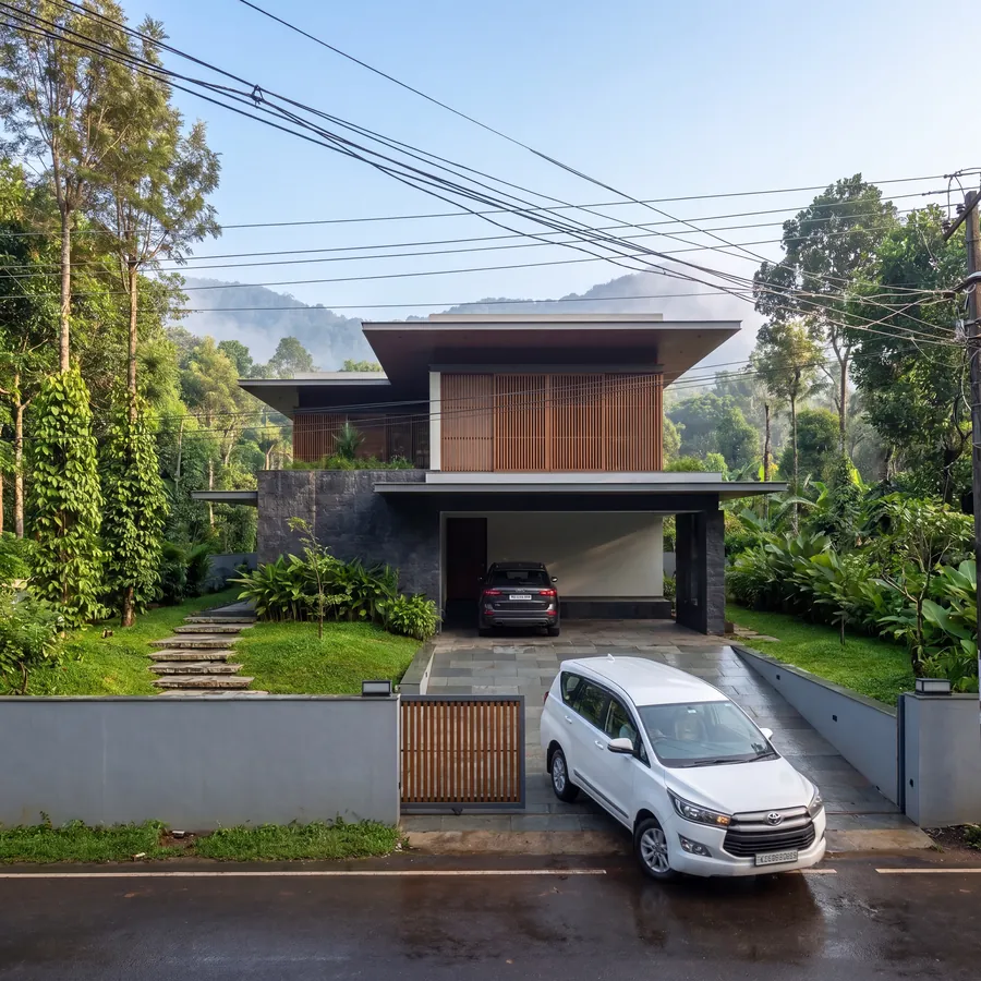 Hillside House by Claycode Architects: house with timber-louvred upper floor and stone-clad base on a hillside