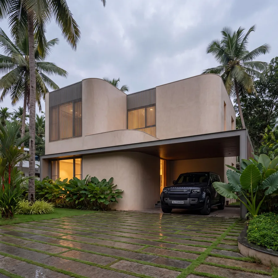 Soft Curve House by Claycode Architects: curving plaster facade with slatted windows and sheltered carport