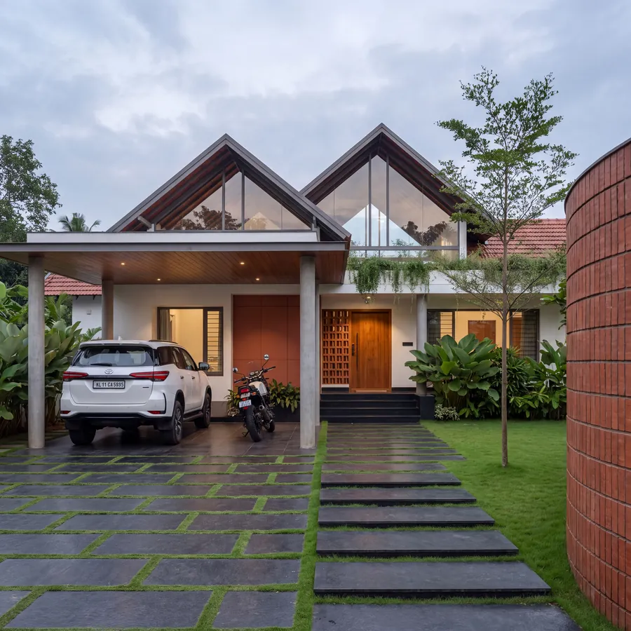 Twin Gable House by Claycode Architects: house with two glazed gables, porch and curved brick wall